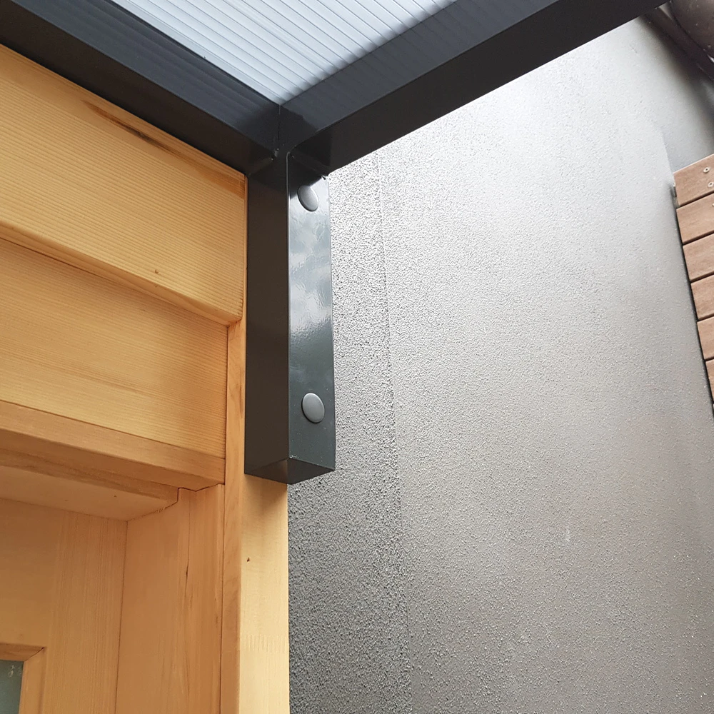 Slimline 50 fixed arm bracket mounted to the wall beside an entry awning frame
