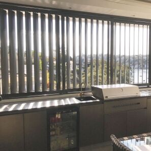 Three-panel 160mm vertical sliding louvres behind an outdoor kitchen.